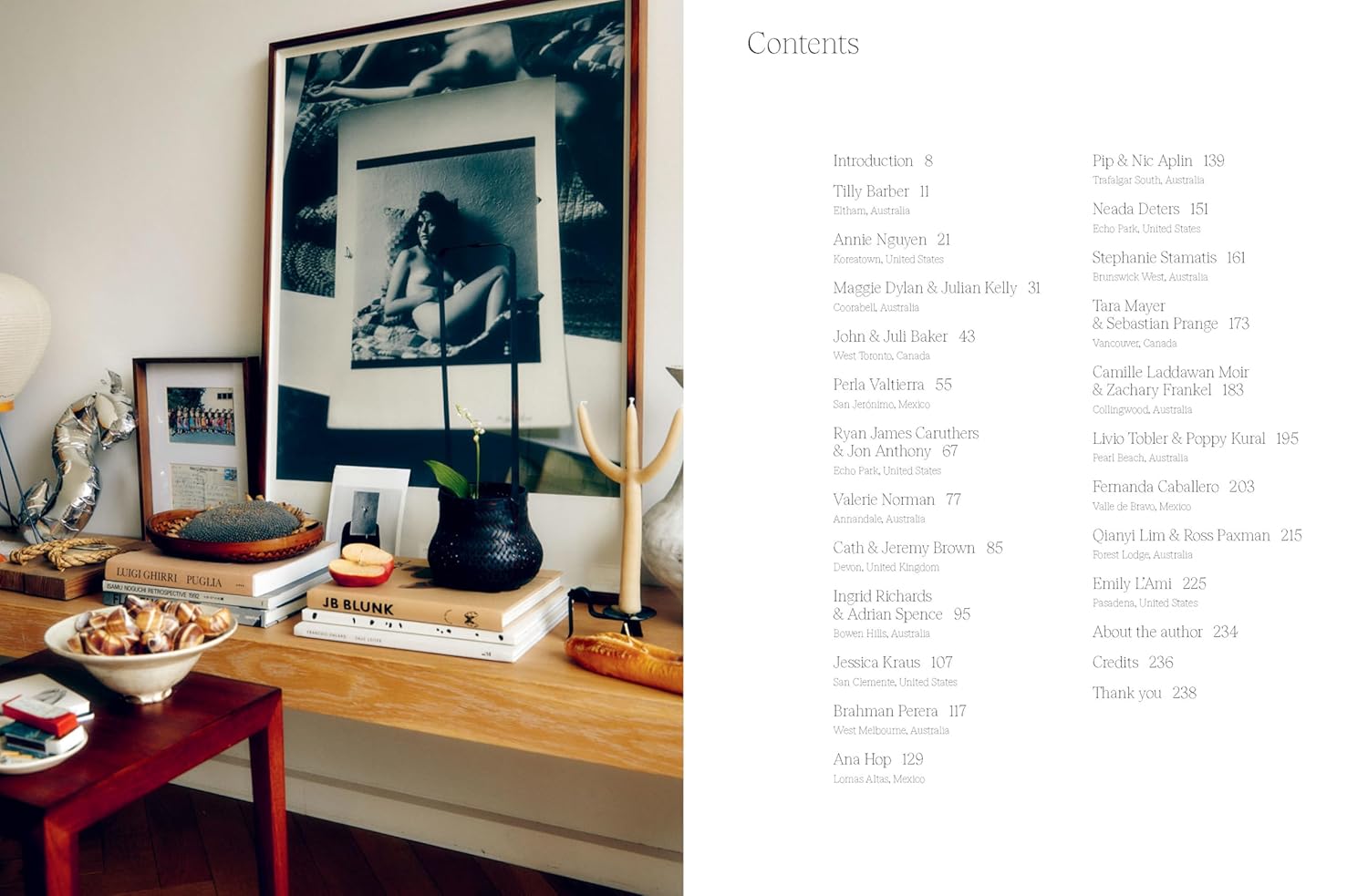 חדר שינה מודרני עם קירות בטון, מיטה לבנה, שטיחים צבעוניים וחלונות מהרצפה עד התקרה; הכיתוב "SANCTUARY" מוטבע. בהשראת ספר עיצוב sanctuary מ-Fine Lab Home—אסתטיקה לבית בתים מעוררי השראה.