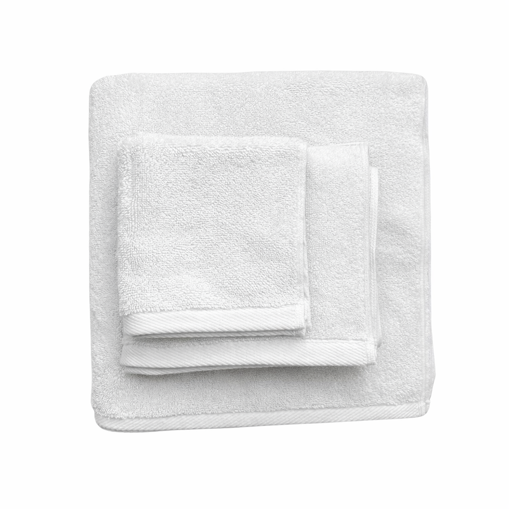 ערימה מקופלת בקפידה של שלוש מגבות גוף איכותיות של Fine Lab Home - צבע לבן על רקע לבן חלק.